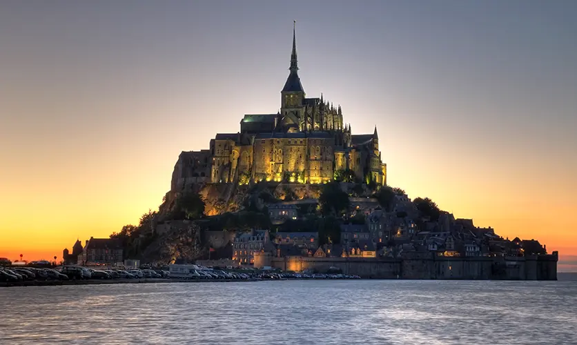 The island abbey of Mont Saint-Michel rising above the bay at sunset