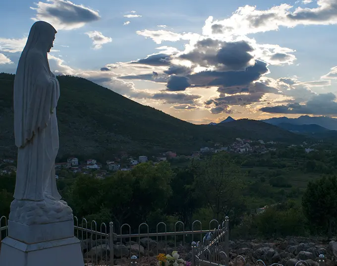 The Queen of Peace statue, sculpted by Dino Felici, marks the summit of Apparition Hill.