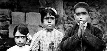 Francisco, Jacinta, and Lúcia, the three Fatima visionaries, holding a rosary in their village of Aljustrel