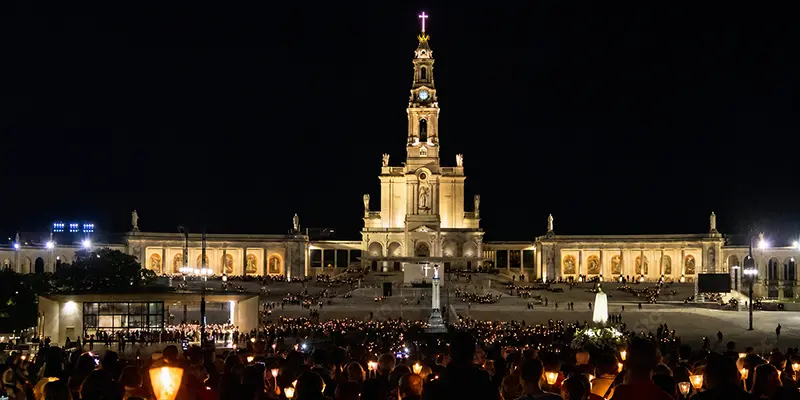 Pilgrims carrying candles during the evening Rosary procession on the esplanade at the Sanctuary of Fatima