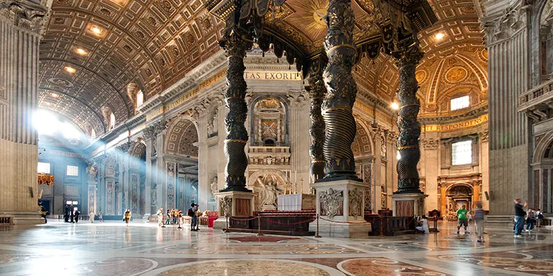 A pilgrim group pauses in St. Peter's Basilica, where the bones of the apostle rest beneath the high altar.