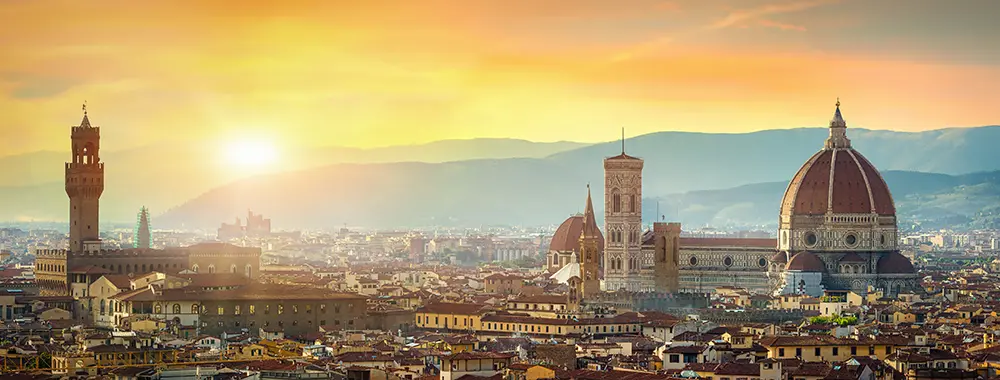 Brunelleschi's terracotta dome of the Florence Cathedral rising above the city's rooftops, with Giotto's bell tower beside it