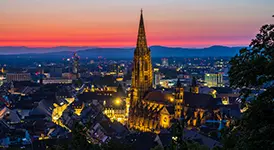 Freiburg Minster and its Gothic spire lit at dusk, Black Forest, Germany