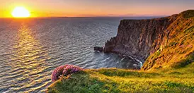 The Cliffs of Moher at sunset, rising sheer above the Atlantic