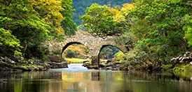 An old stone bridge over the water in the lakelands of Killarney