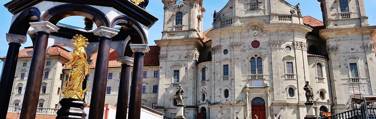 Einsiedeln Abbey with the golden statue of Our Lady in the forecourt, Switzerland