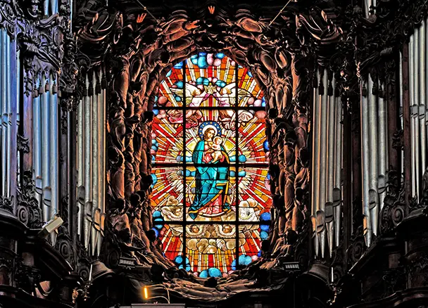 Ornate Rococo pipe organ with gilded carvings and angel figures in Oliwa Cathedral, Gdańsk, Poland