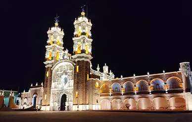 The Basilica of Our Lady of Ocotlán in Tlaxcala, its twin towers illuminated against the night sky