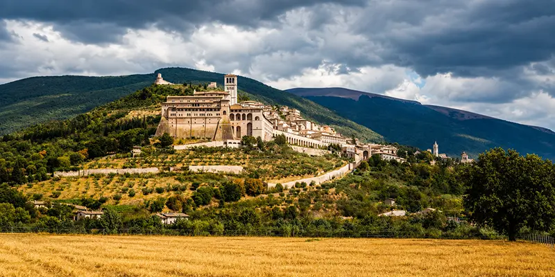 The town of Assisi and the Basilica of St. Francis on the slope of Mount Subasio in Umbria, Italy