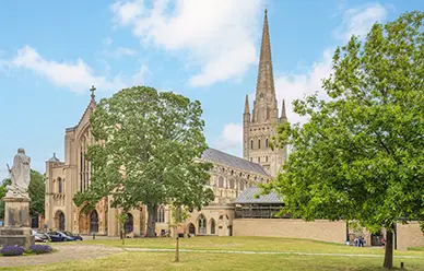 Norwich Cathedral and its spire, the second tallest in England, seen across the green of the Cathedral Close