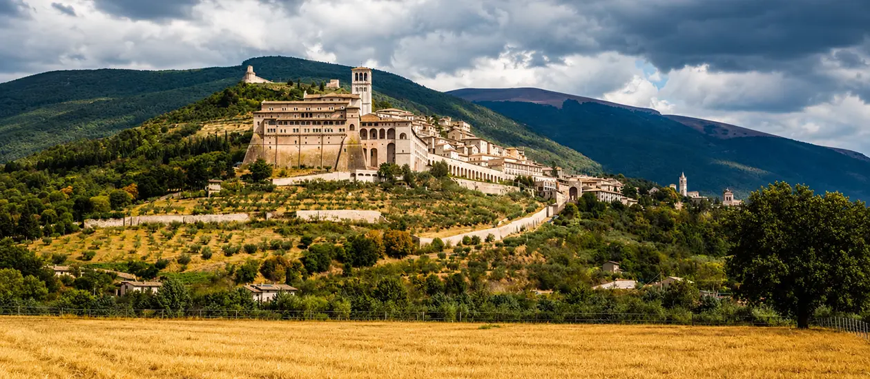 The town of Assisi and the Basilica of St. Francis on the slope of Mount Subasio in Umbria, Italy