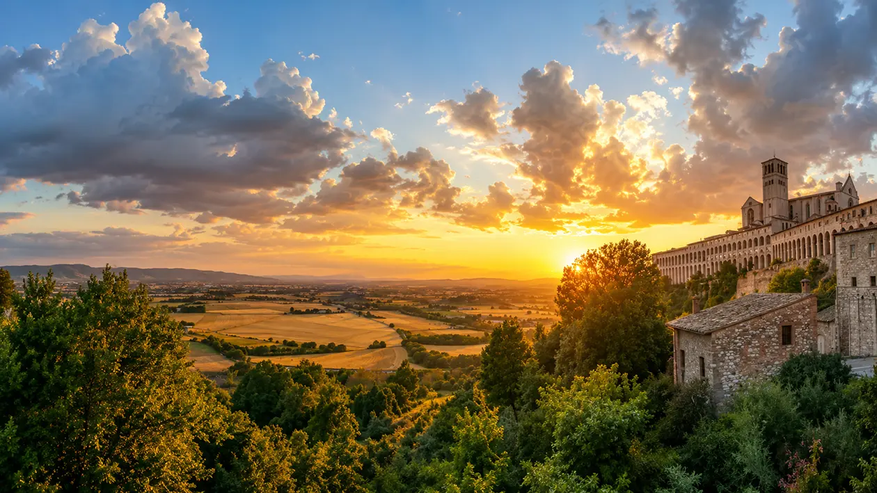 The hilltop town of Assisi and the Basilica of Saint Francis at golden hour, with the Umbrian valley below